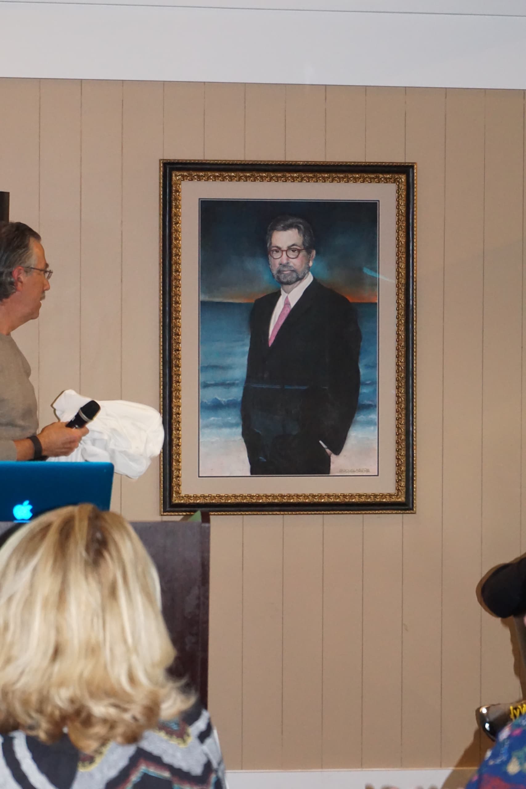 Dr. Douglas presents his painting of the late Dr. DiGregorio