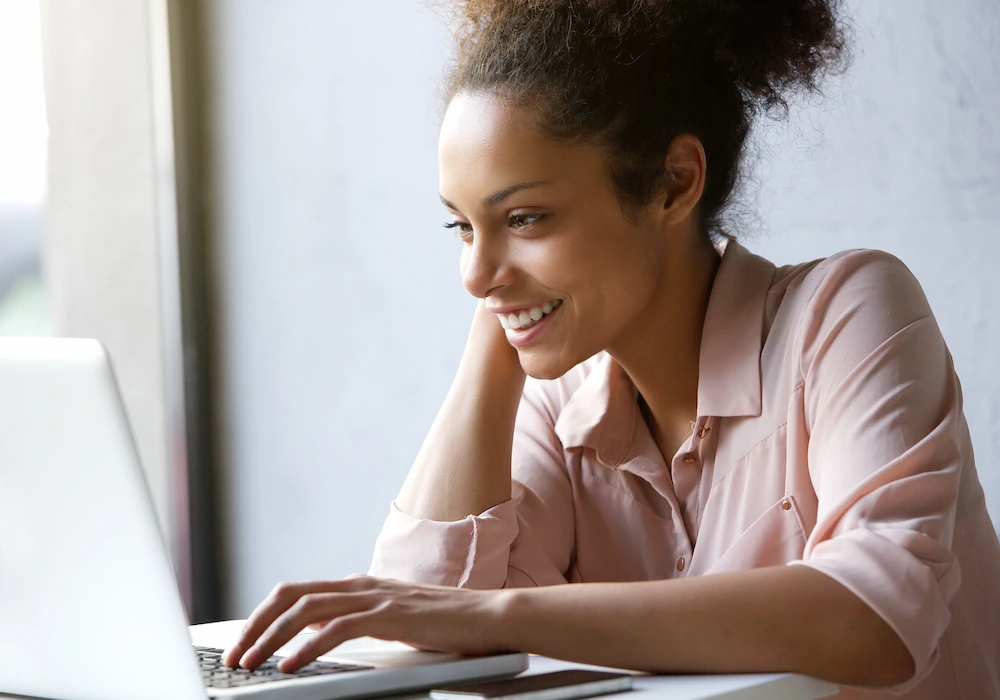 Woman smiling while on the computer