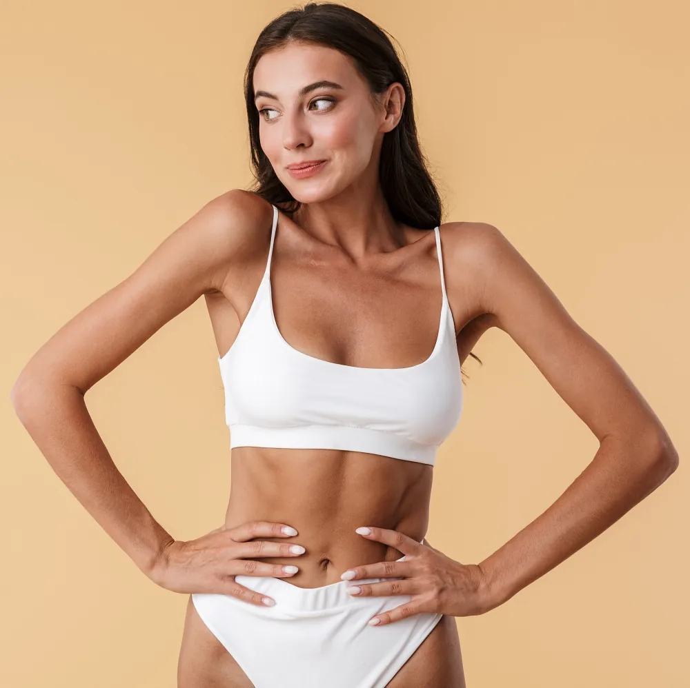 Confident woman in white underwear before breast asymmetry surgery